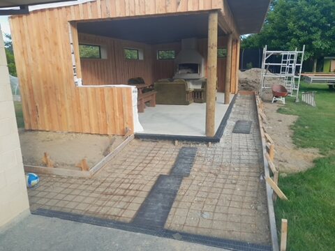 Pavilion part-way through construction with the fireplace built and paving going down