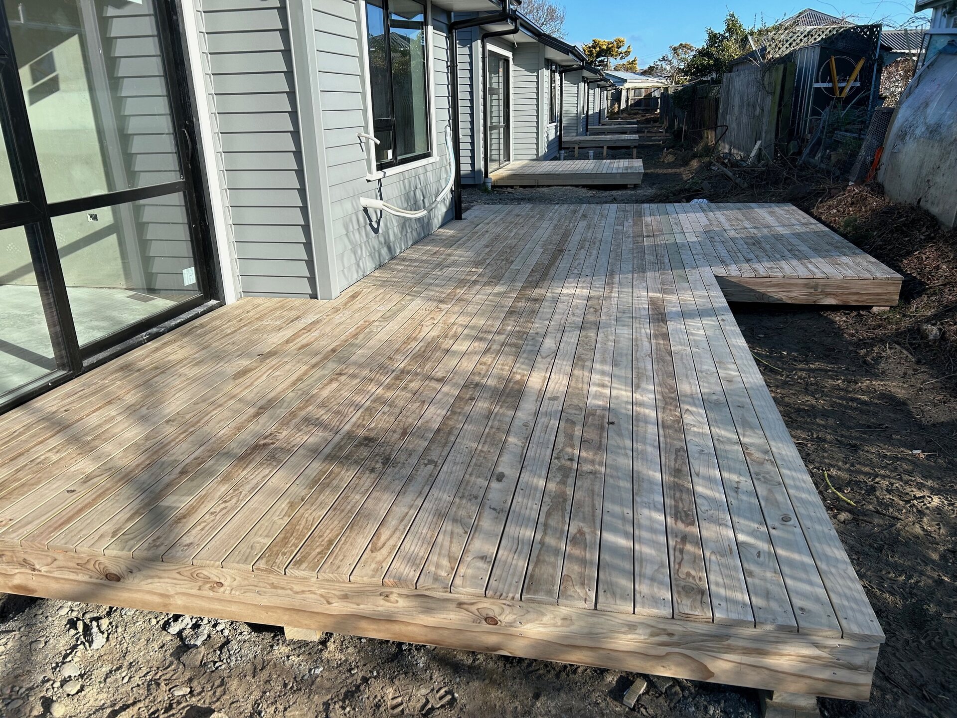 Timber deck under construction, boards laid and framing visible at the edge
